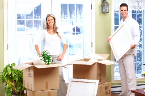 Moving team using safe lifting techniques and PPE