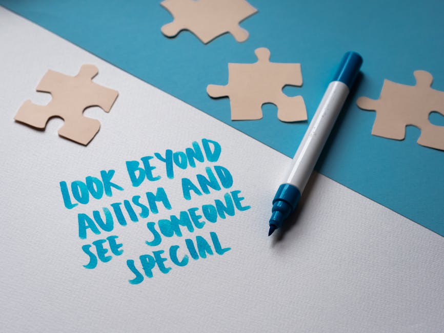 Close-up image of a white textured surface with a handwritten message in blue marker that reads 'Look beyond autism and see someone special.' Several beige jigsaw puzzle pieces are scattered around th